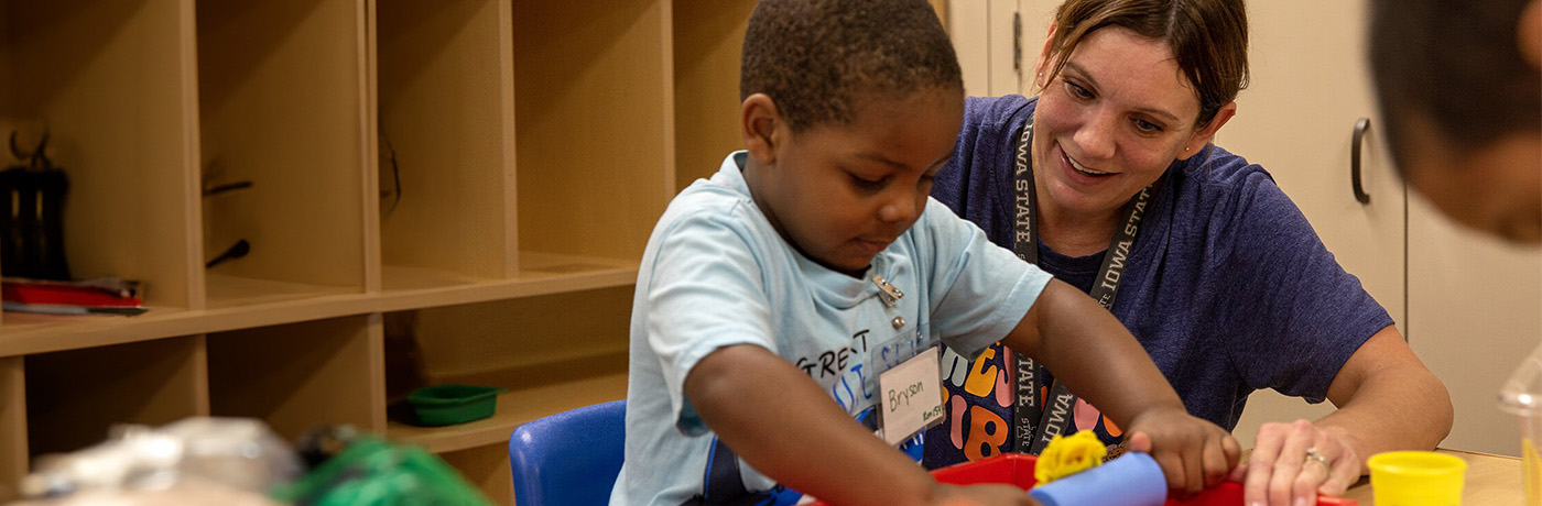 teach and student playing with playdough